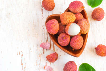 Ripe lychees in a bowl on a white background. Top view with copy spaceの写真素材