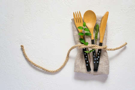 set of bamboo cutlery and napkin on a white background. Natural table settingの写真素材