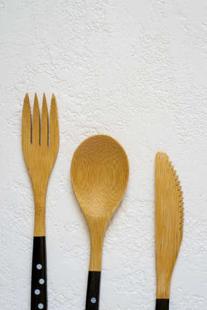 Bamboo fork, knife and spoon on white background closeup, Top view with copy spaceの写真素材