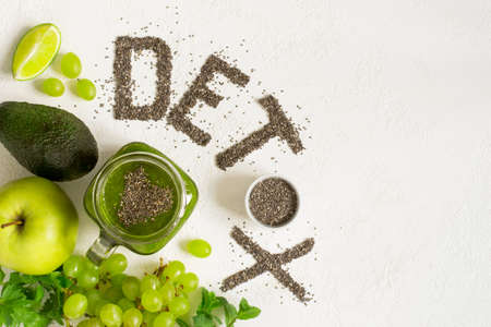 Word detox is made from chia seeds. Green smoothies and ingredients. Concept of diet, cleansing the body, healthy eating. Top view with copy spaceの写真素材
