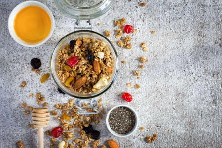 Granola with dry fruits, nuts and honey. Healthy breakfast set. Top view with copy spaceの写真素材