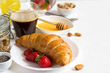 Healthy breakfast set: croissant, berries, and coffee. Selective focus and copy spaceの写真素材