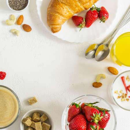 Food background with Assorted  ingredients for breakfast on white background. Top view with copy spaceの写真素材