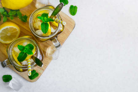 Green ice tea with lemon and mint in a glass jar. Top view with copy spaceの写真素材