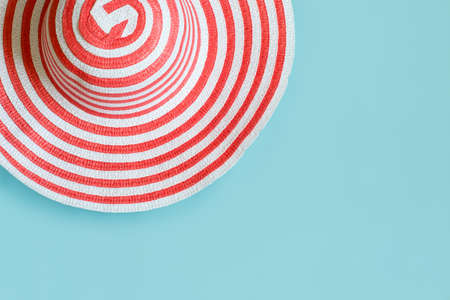 Women's striped summer romantic hat for beach holiday. Top view with copy space, flat layの写真素材