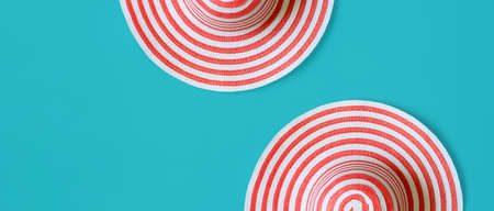Women's striped summer romantic Hats On a turquoise background. Top view. Concept of summer holidaysの写真素材