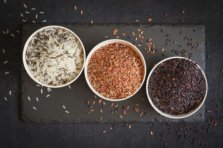 Assorted of variety of gourmet rice in bowls On black background. Top viewの写真素材