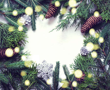 Christmas natural background. Coniferous branches, Cones and decor lie around. Toned. Bokeの写真素材