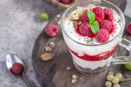 Dessert or breakfast with raspberries and yogurt in glass closeup.の写真素材