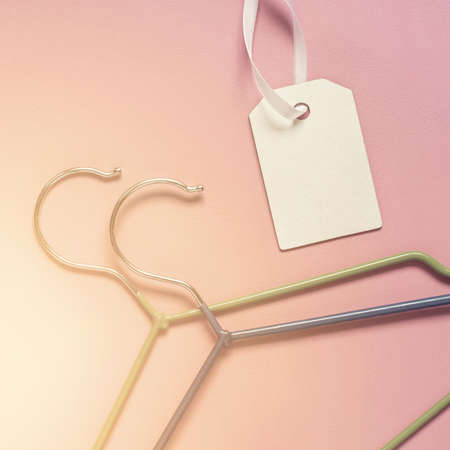 Hangers for clothes and tag on a pink background. Sale, discount, trade conceptの写真素材