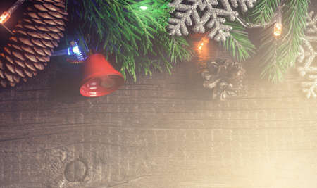 Christmas Vintage wooden background. Border of Coniferous branches and snowflakes