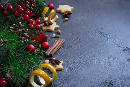 Christmas background border of fir branches and Christmas toys and spices.の写真素材