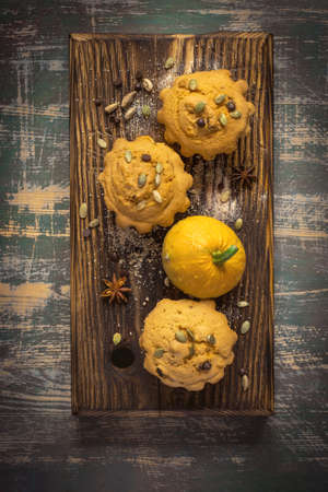 Autumn pumpkin muffins with spices, chocolate drops and pumpkin seedsの写真素材