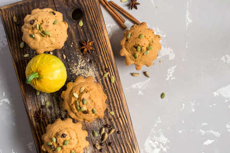 Autumn pumpkin muffins with spices, chocolate drops and pumpkin seeds.の写真素材
