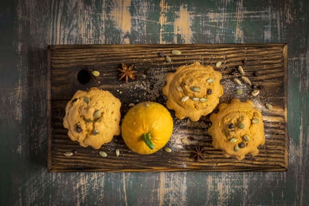 Autumn pumpkin muffins with spices, chocolate drops and pumpkin seeds.の写真素材
