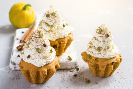 Autumn pumpkin muffins with spices, chocolate drops and pumpkin seeds