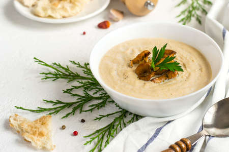 Mushrooms chanterelle cream soup on white background.の写真素材