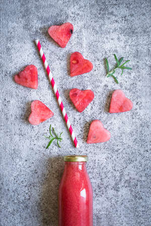 Watermelon juice in a bottle And pieces of watermelon in the form of a heartの写真素材