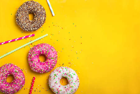 Yellow food dessert background with various donuts.の写真素材