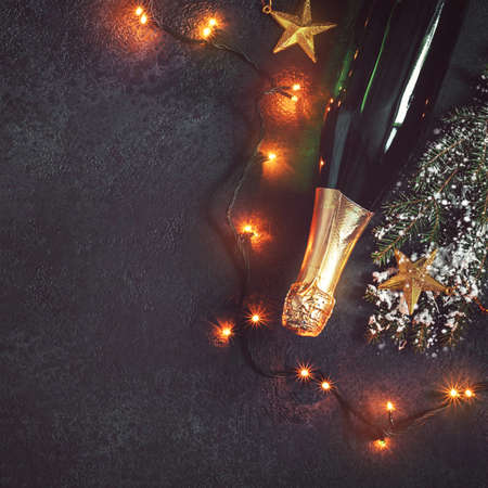Christmas background with champagne and luminous garland.の写真素材