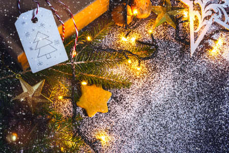 Christmas card background with Christmas fir, gift and gingerbread.