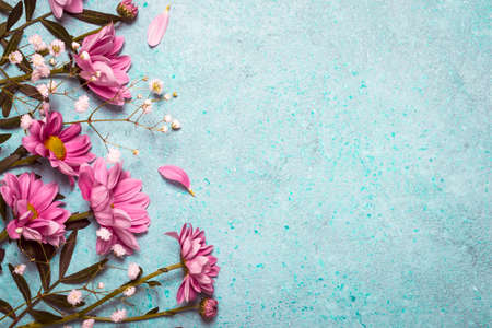 Spring Summer Creative nature background. Pink flowers border on vintage blue backgroundの写真素材