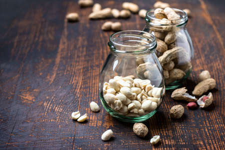 Peanut snack in jar on dark background.の写真素材