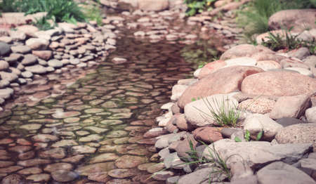 Slow trickle with large pink pebbleの写真素材