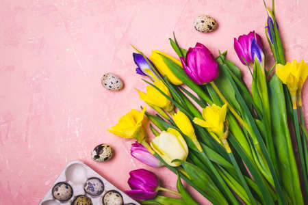 Easter flat lay composition. A bouquet of spring flowers and quail eggs.の写真素材