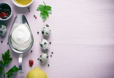Mayonnaise sauce and ingredients on pink cloth background.の写真素材