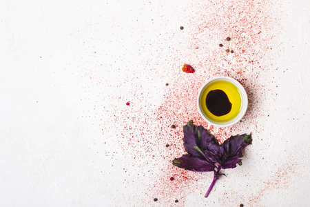 Olive oil and sprig of basil on a white background.の写真素材