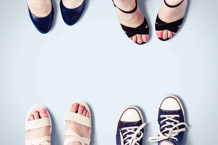 Assorted summer women's shoes. Female feet in sandals, sneakers, shoes. Fashion background.の写真素材