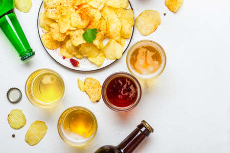Assorted light and dark Beers and chips.の写真素材