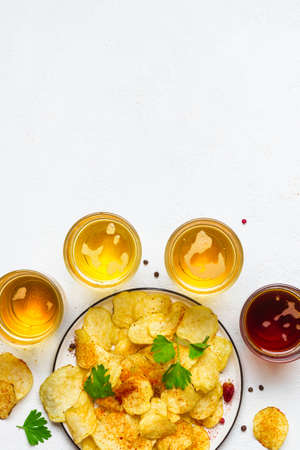 Assorted light and dark Beers and chips.の写真素材