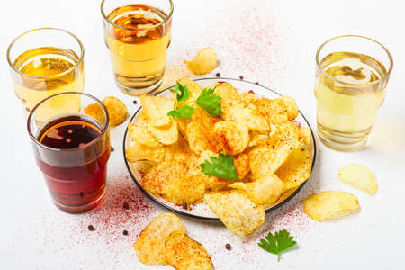 Assorted light and dark Beers and chips.