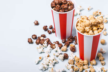 Assorted popcorn set in paper striped white red cup.の写真素材