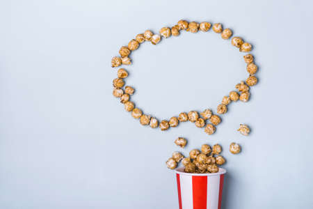 Sweet caramel popcorn in paper striped white red cup.の写真素材