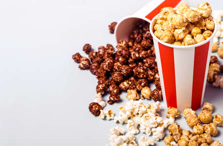 Assorted popcorn set in paper striped white red cup. Sweet and salty popcorn.の写真素材