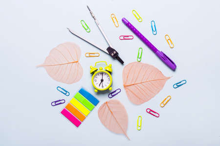 School supplies and orange leaves on a blue background. Back to school concept.の写真素材