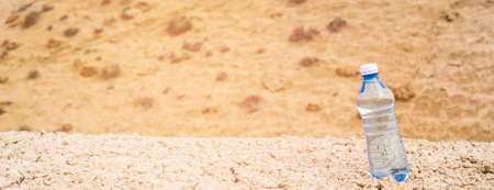 Clean drinking water in bottle in dry hot desert.の写真素材