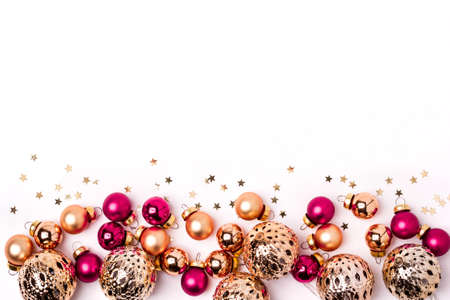 Christmas white background. Shining gold and pink balls and confetti border.