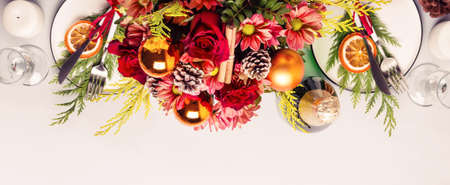 Christmas table setting. border of flowers, conifers and dishes. Banner formatの写真素材