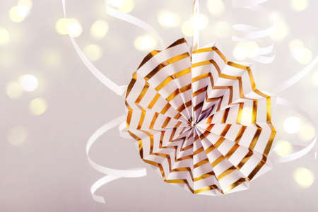 Paper decoration and bokeh lights. Gold Holiday party  or greeting card.の写真素材