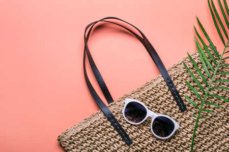 Stylish straw bag and sunglasses. Concept of summer holidays.の写真素材