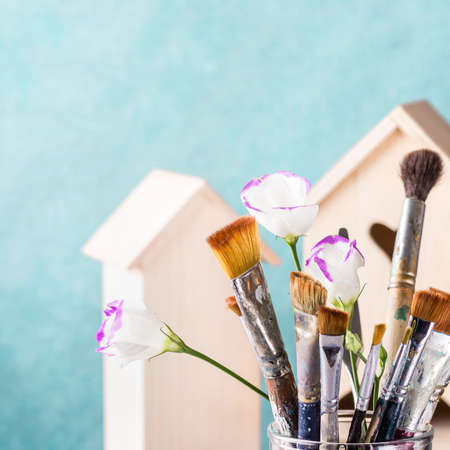 Art Brush Set and wooden house for decoration on turquoise background.の写真素材