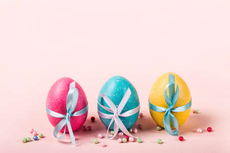 Three decorated eggs are in a row. Easter concept.