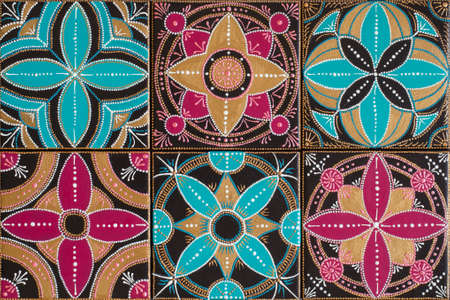 Handmade painting tile. Geometrical ornament and bright colors.