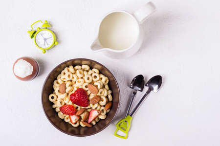 Balanced traditional breakfast. Whole grain rings, berries and egg on a white table.の写真素材