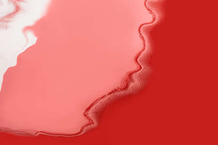 Acrylic Fluid Art. Pink and red waves penetrate each other. Abstract swirling background or texture.