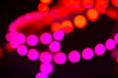 Duotone Red and purple neon lights on black. Abstract night blurred background.